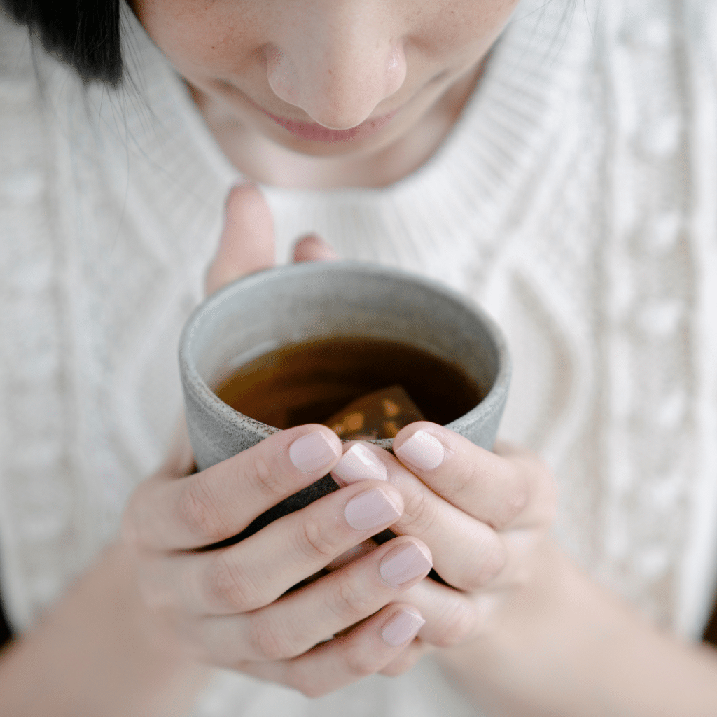 Girl holding cup of herbal tea